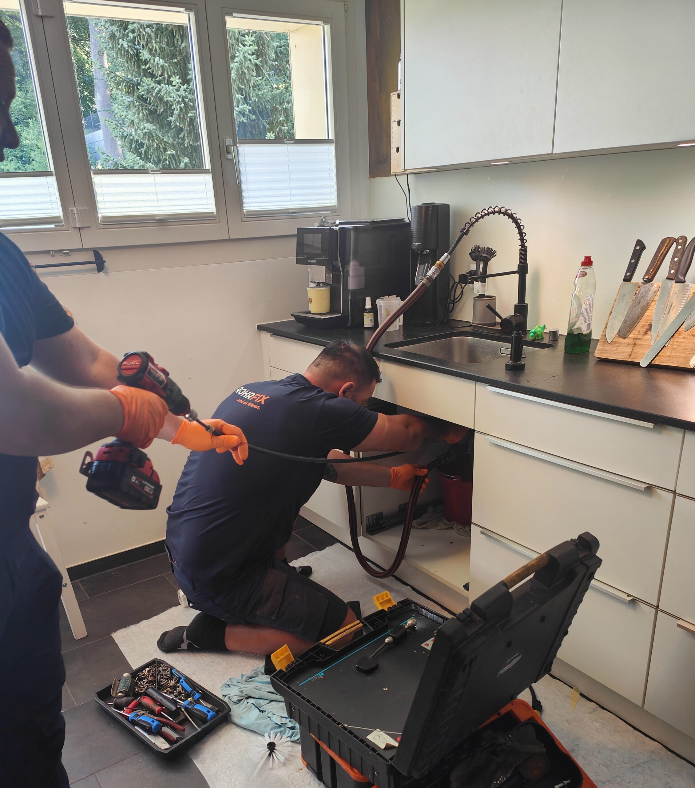 ROHRFIX Mitarbeiter beim 24/7 Notfalldienst für einen verstopften Küchenablauf in einer Wohnung.